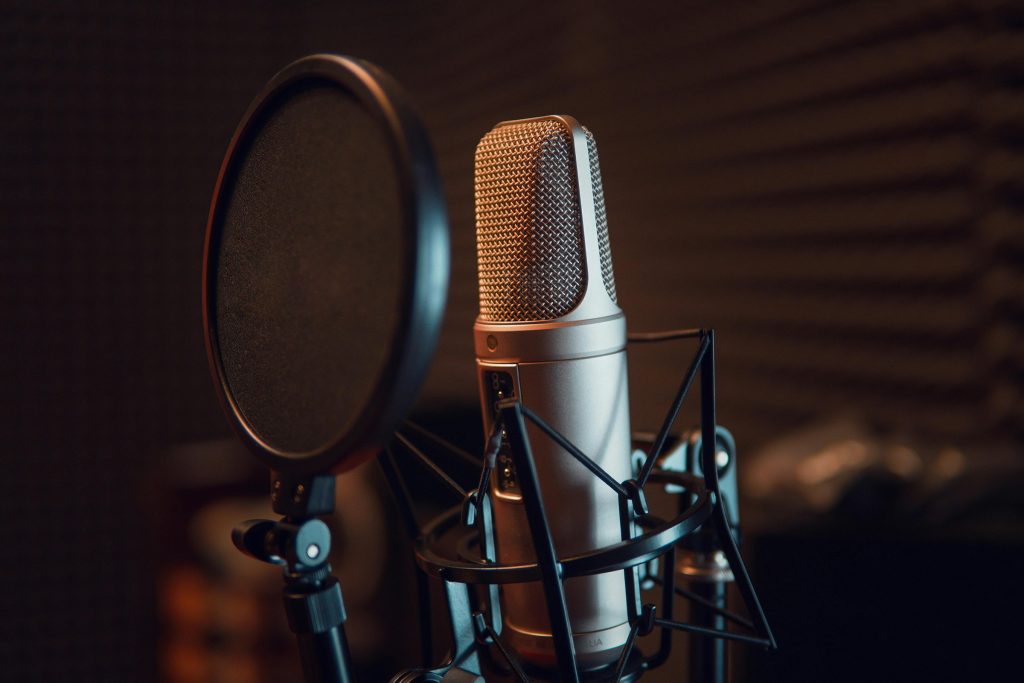 A professional microphone and pop filter in a recording studio for voice-over