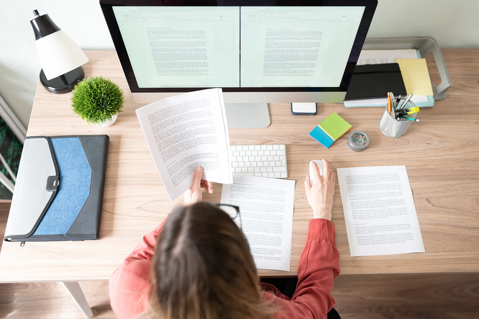 Top view of the workspace of a female translator working on a document translation